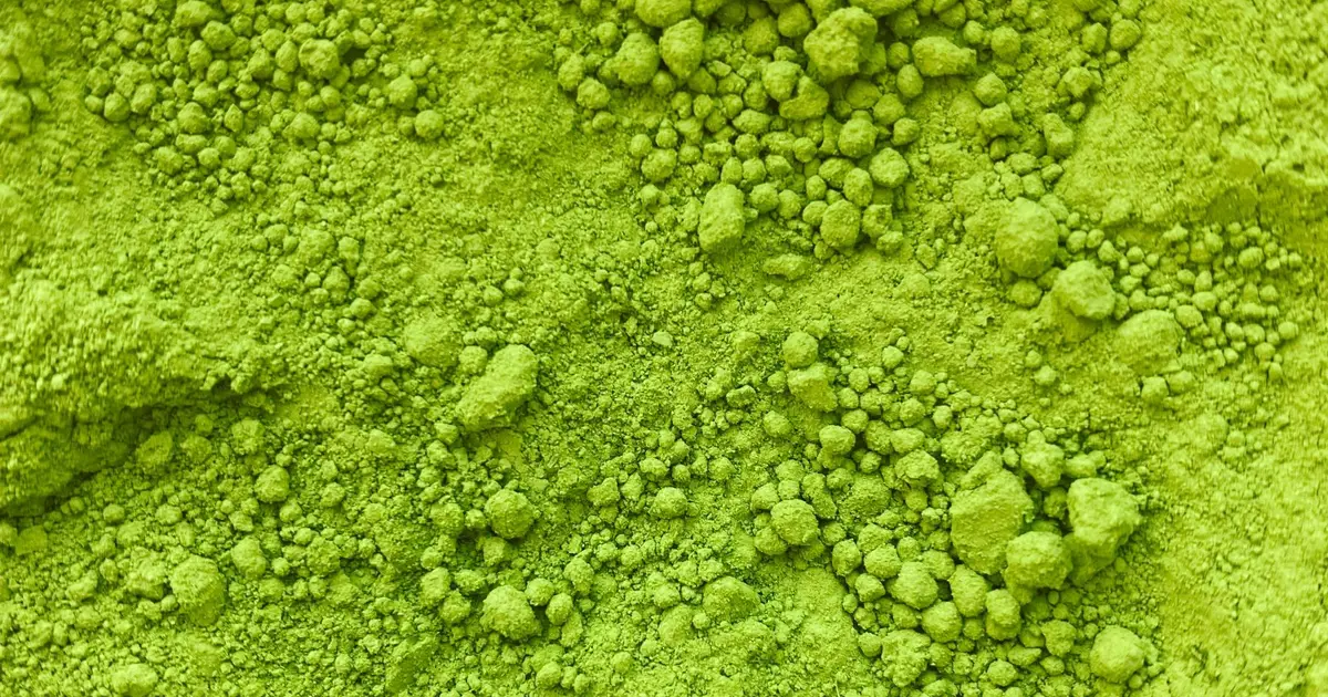 Close-up of fine bright green tea powder, the finished product of green tea powder milling